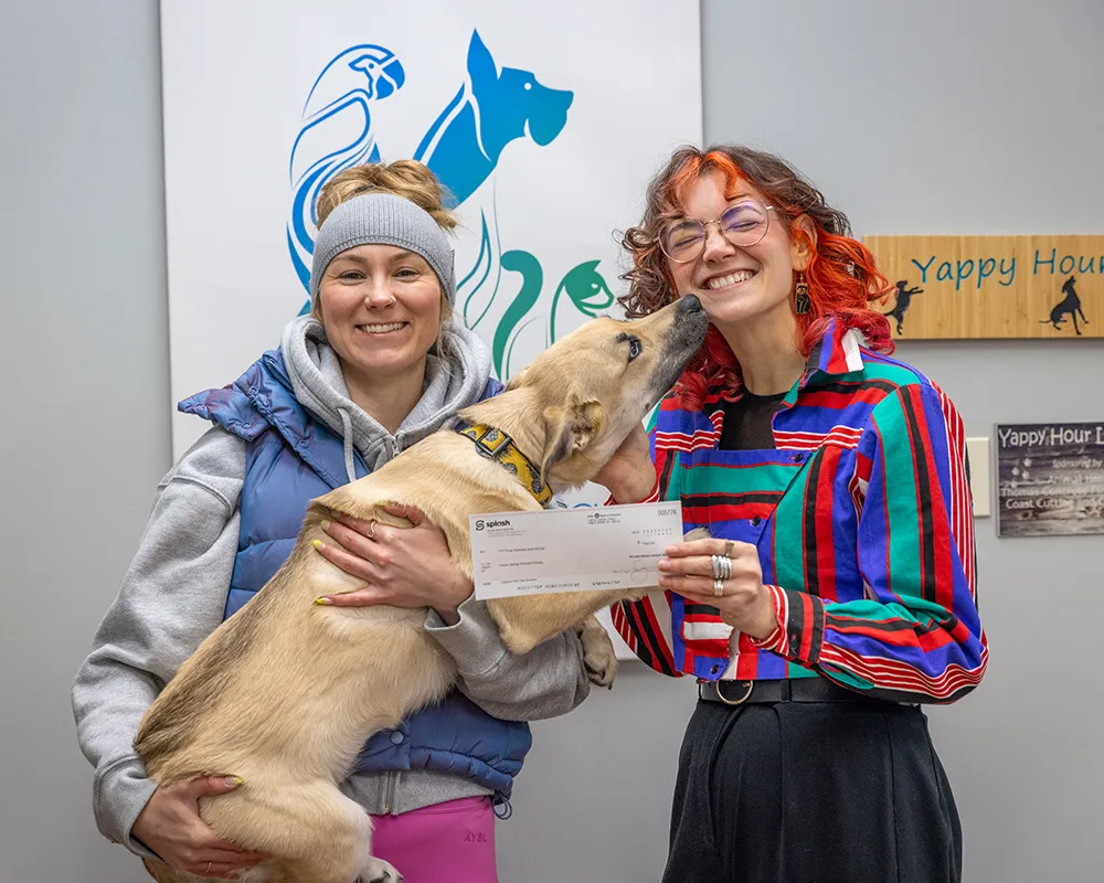 Timea passing check along to Humane Society volunteer